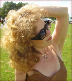 Linda in sunglasses with hands running through hair